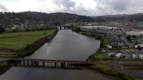 aerial flying over train track bridge going over slough, coos bay, oregon