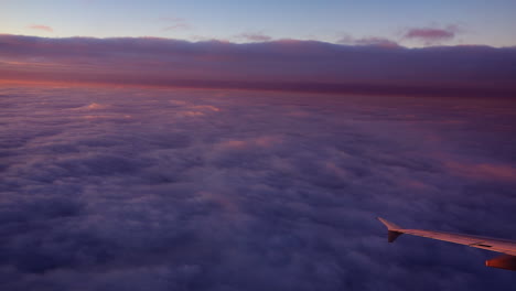 sunrise above the clouds viewing the plane wing