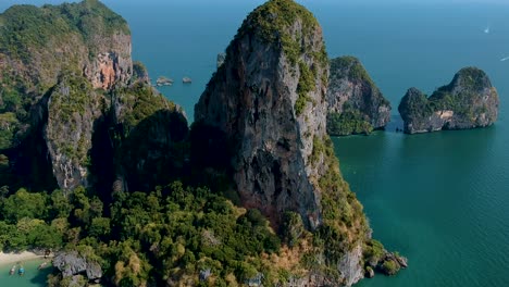 Beautiful-energetic-aerial-shot-of-large-limestone-karst-at-Railay-Beach,-Ao-Nang,-Krabi,-Thailand