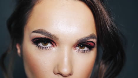 beautiful brunette with painted eyebrows and eyelashes. make up on female face