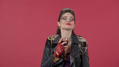 woman in 1980s style leather jacket with wine glass
