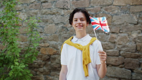 teenager holding british flag