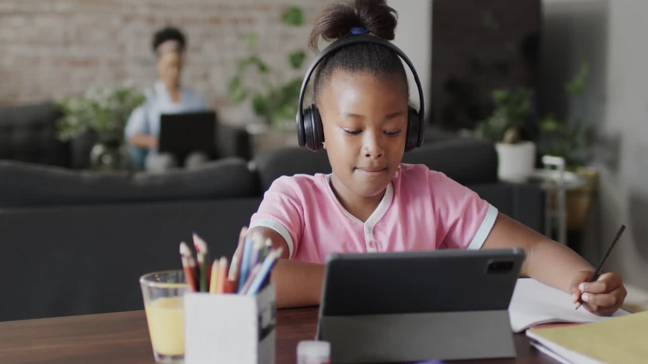 African american girl using tablet for online lesson, slow motion