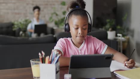 african american girl using tablet for online lesson, slow motion