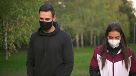 people wearing masks in a park