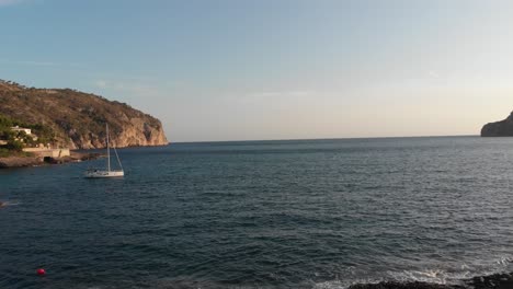 Sailboat-anchored-at-sunset-in-the-Mediterranean,-Majorca,-Spain