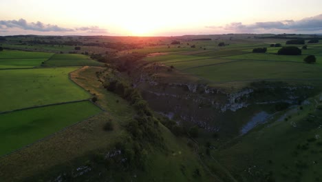 beautiful lathkill dale - drone flies towards the golden sunset, the peak district, derbyshire, uk - valley top