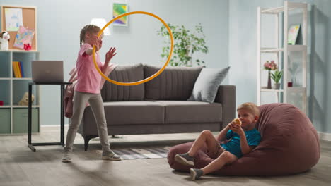 girl turns gymnastic ring boy eats bun in living room