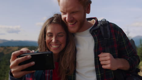 couple watching funny video on mobile phone