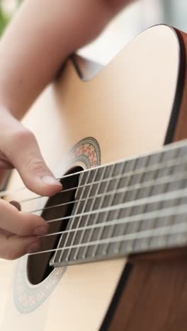 person playing ukulele at home. – closeup shot
