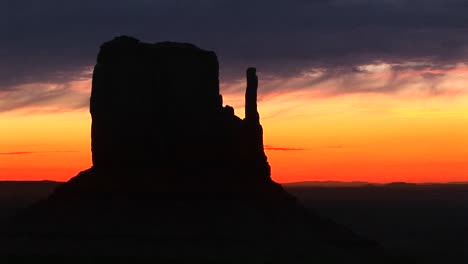 medium shot of left mitten in monument valley arizona silhouetted at goldenhour