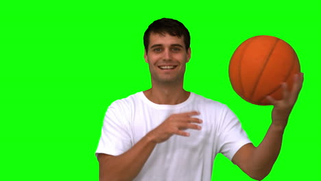 Man-playing-with-a-basketball-on-green-screen