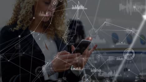 animation of network of connections over businesswomen using smartphone at the airport
