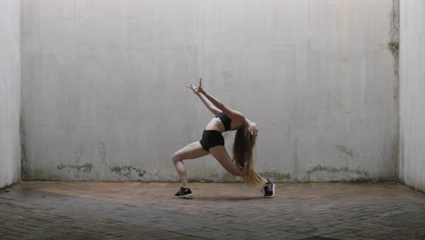 dancing-woman-attractive-young-caucasian-street-dancer-performing-contemporary-moves-enjoying-modern-dance-expression-practicing-in-grungy-warehouse