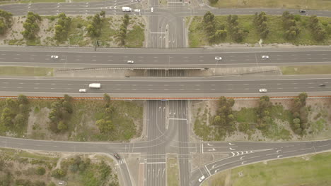 static aerial perspective of major highway intersection with vehicles traveling in all directions