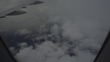 view from the window of an airplane above the clouds