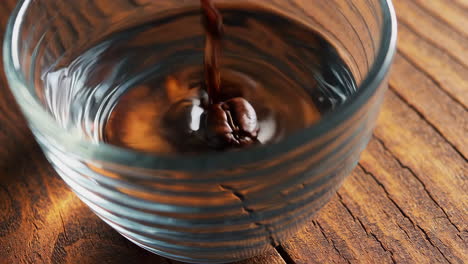 coffee bean and espresso dropping into a glass
