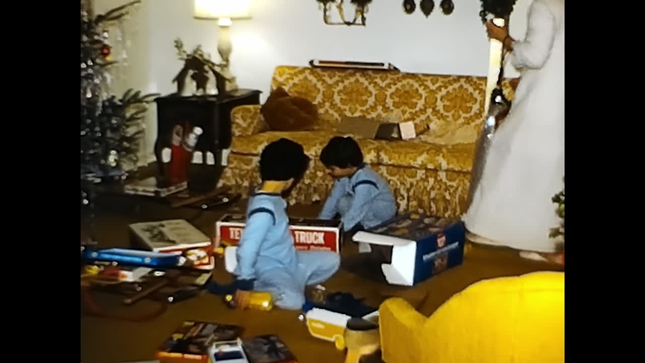 Two Young Boys Playing With Toys in a Living Room. CIRCA USA - 1970s: Two boys in the 1970s playing with toys together in a living room.
