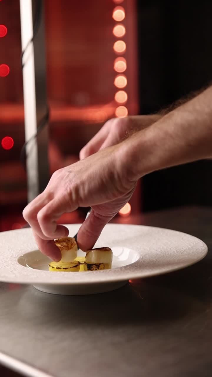Chef plating scallops