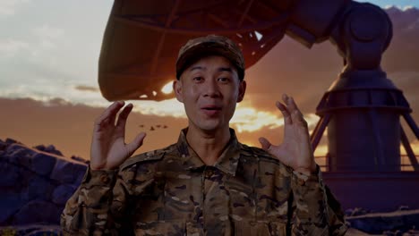 close up of asian man soldier smiling and saying wow while standing with satellite dish