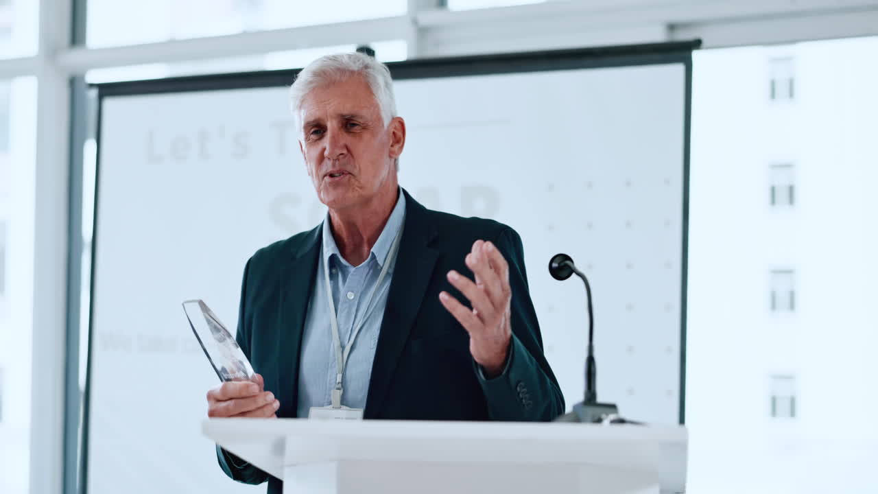 Senior Man Speaking at Podium with Award During Business Presentation