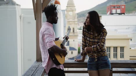 young adult friends hanging out on a rooftop