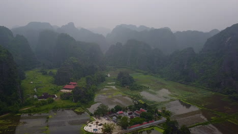 Experience the serene beauty of a rainy day in the mountainous region of Ninh Binh, Vietnam. This view captures the misty atmosphere and lush landscapes of this captivating destination.