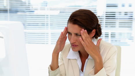 businesswoman getting stressed at her desk