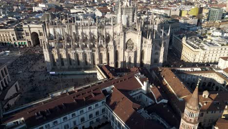 aerial top down view of milan downtown duomo cathedral , drone revealing skyline cityscape during a sunny day of summer