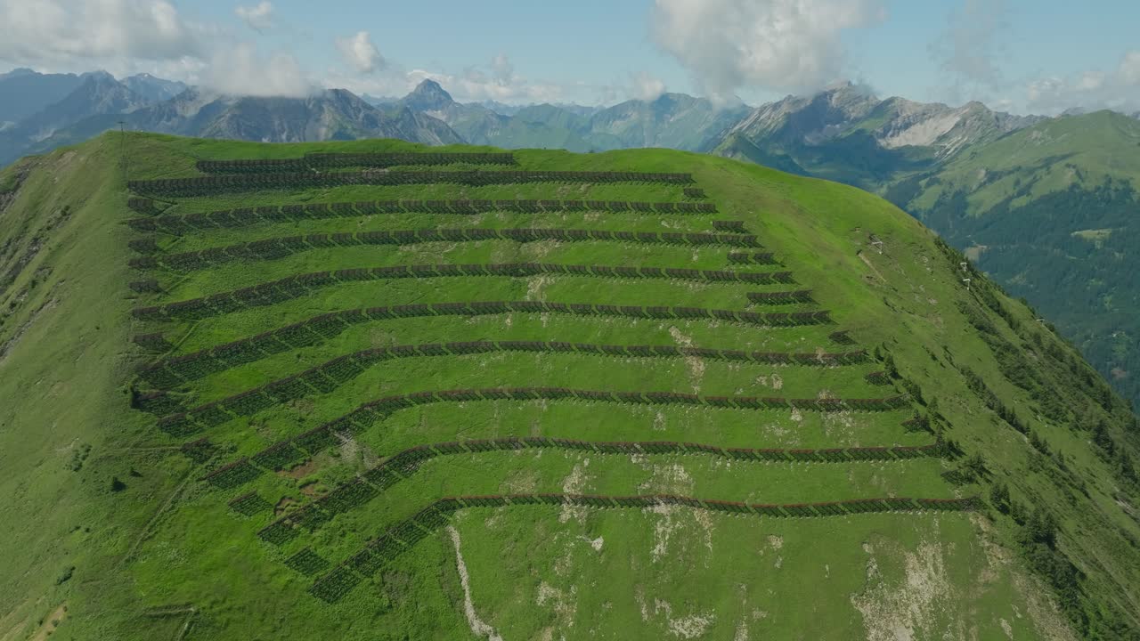 Snow breakers on a lush green mountain in Berwang, Austria with stunning alpine views in summer
