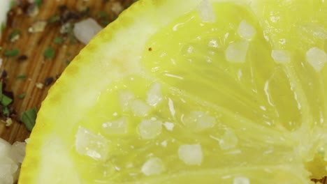 Macro-shot-of-salt-grains-falling-in-a-lemon-slice