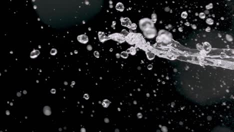 spattering water on a black background