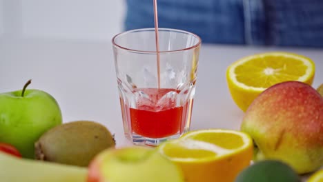 Woman preparing juice in the kitchen. Close up of woman preparing healthy fruit juice