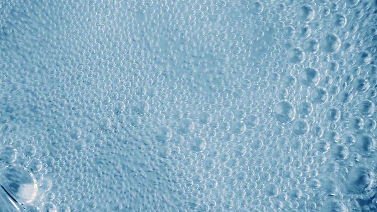 Oxygen bubbles in water on a blue abstract background