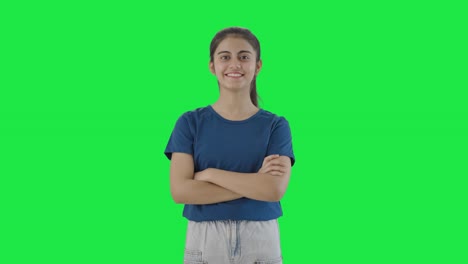 Happy-Indian-teenage-girl-standing-crossed-hands-Green-screen