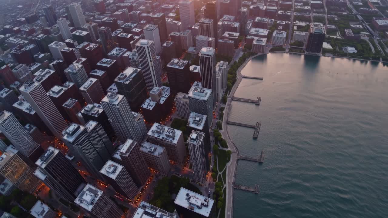 따뜻한 황금빛의 빛은 현대적인 마천루를 비추고, 아침 일찍 시내 풍경의 파노라마를 통해 시내 해안가에 극적인 긴 그림자를 던집니다.