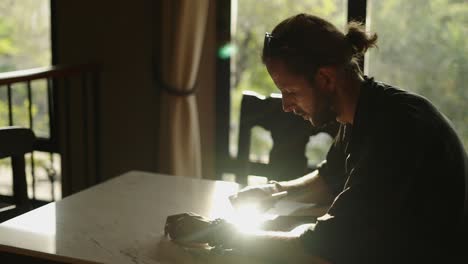 man concentrating on digital tablet in sunlight