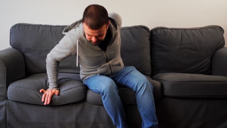 Bearded-Caucasian-Guy-Lying-Down-In-A-Couch-At-Home