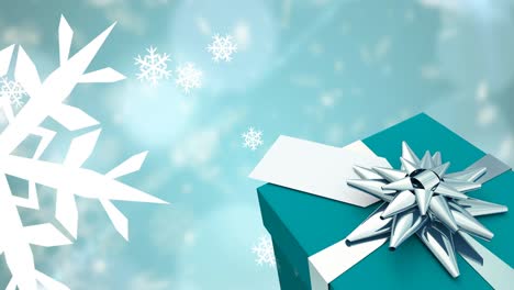 animación de la caída de copos de nieve sobre el regalo de navidad y
