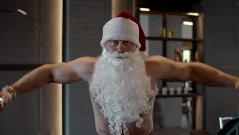 Sexy-santa-claus-doing-bicep-curls-in-sport-club.-Sportsman-training-at-gym