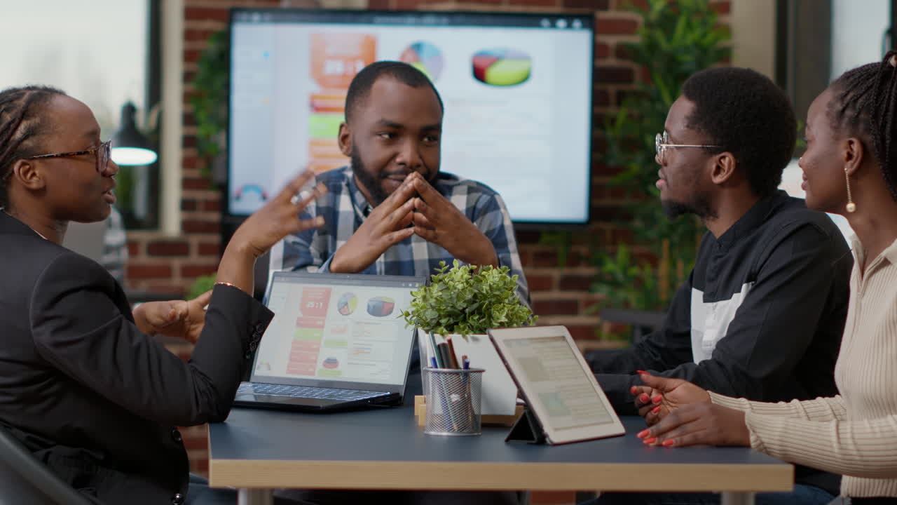 Team of african american businesspeople meeting in boardroom office