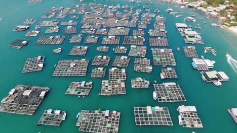 Aerial-overview-of-fishing-industry-in-Vietnam,-fish-farms-in-bay-and-scenic-coastal