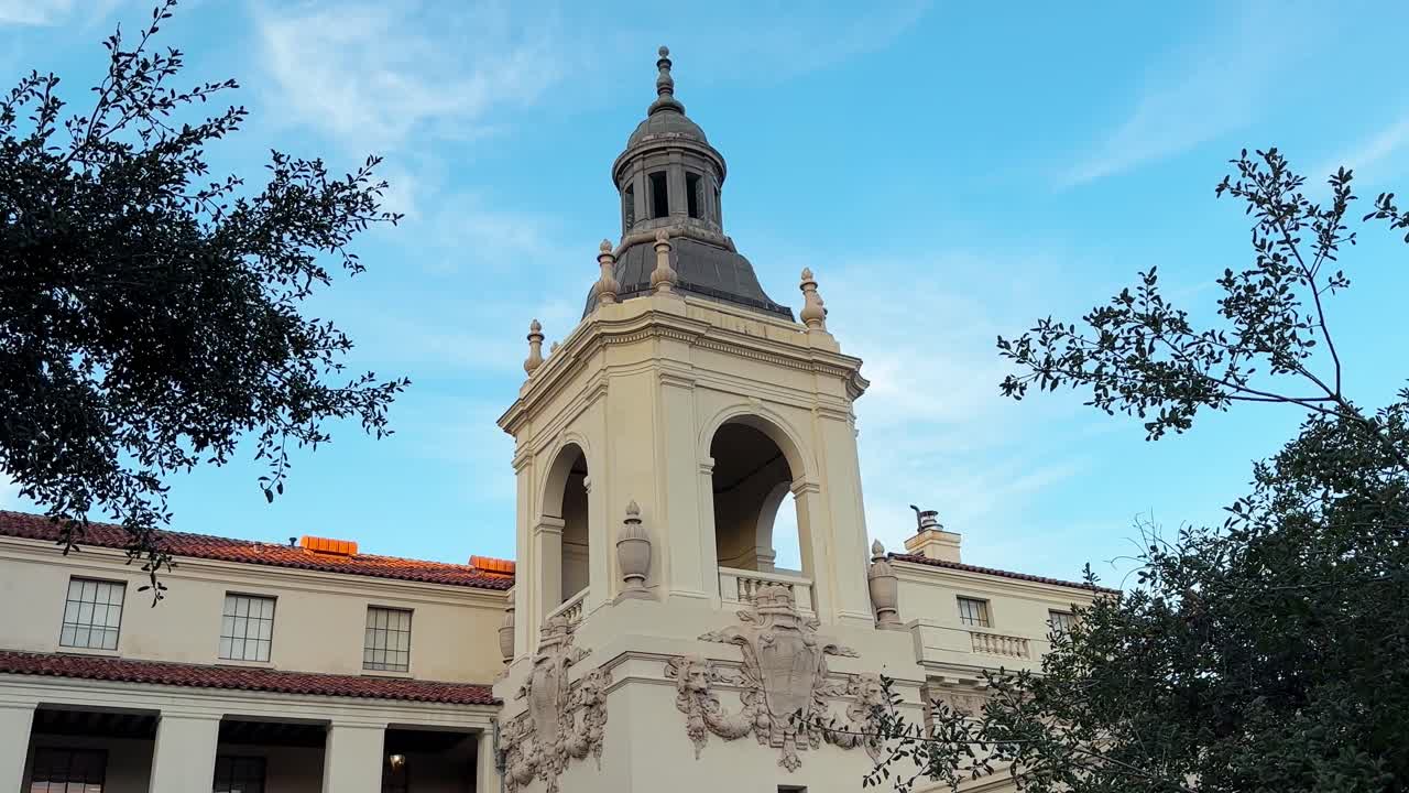 edificio cuadrado centenario con fondo de cielo azul, en el ayuntamiento de pasadena enmarcado alrededor de árboles