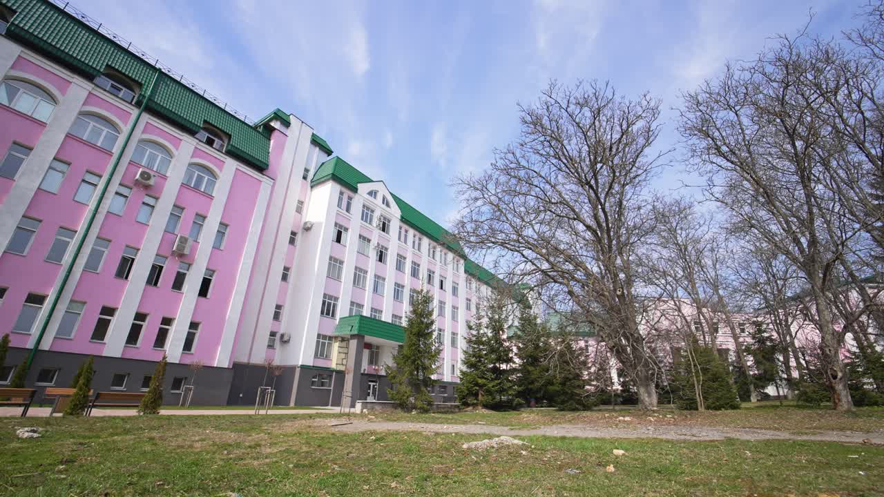 Modern educational establishment for higher education. Main student corpus of university. Park leading to the main building entrance.