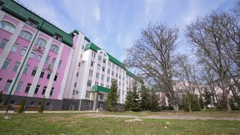 modern educational establishment for higher education. main student corpus of university. park leading to the main building entrance.