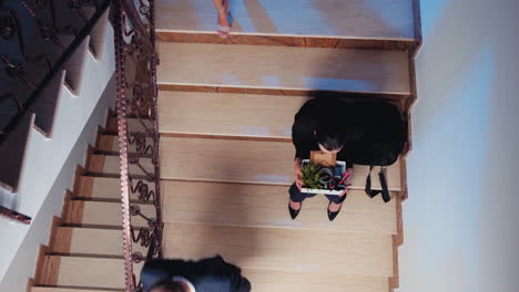 Top-view-of-business-woman-getting-fired-sitting-on-stairs