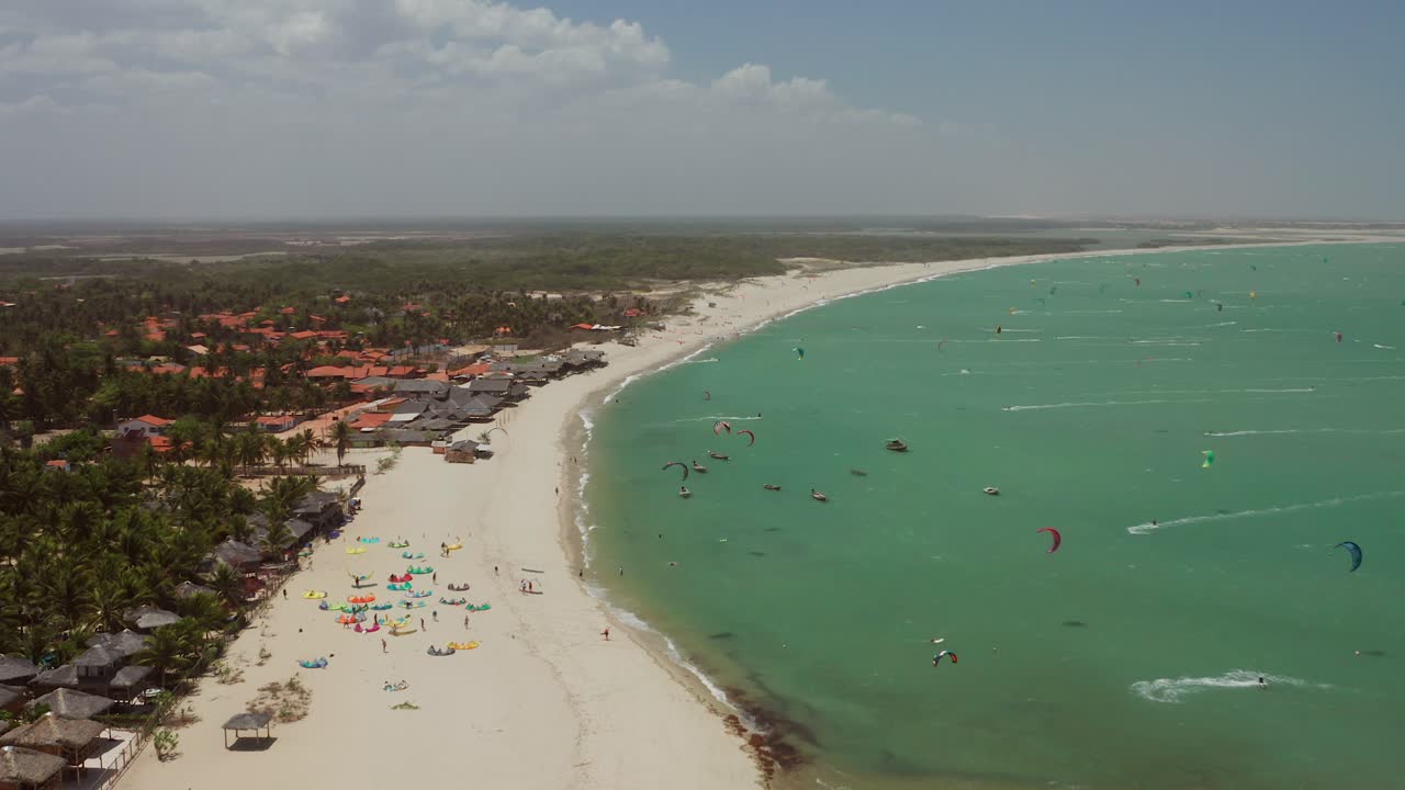 Aerial view of a beach with kitesurfing activities