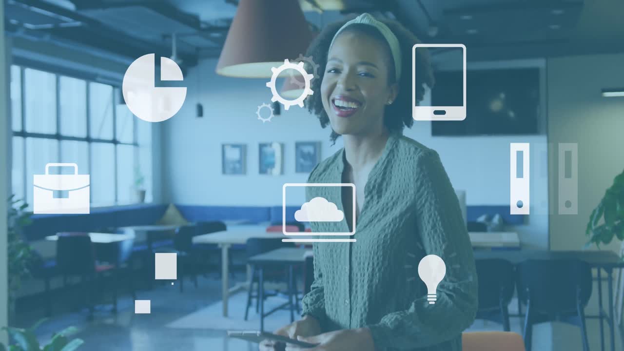 Animation of digital icons against african american woman using tablet and smiling at office