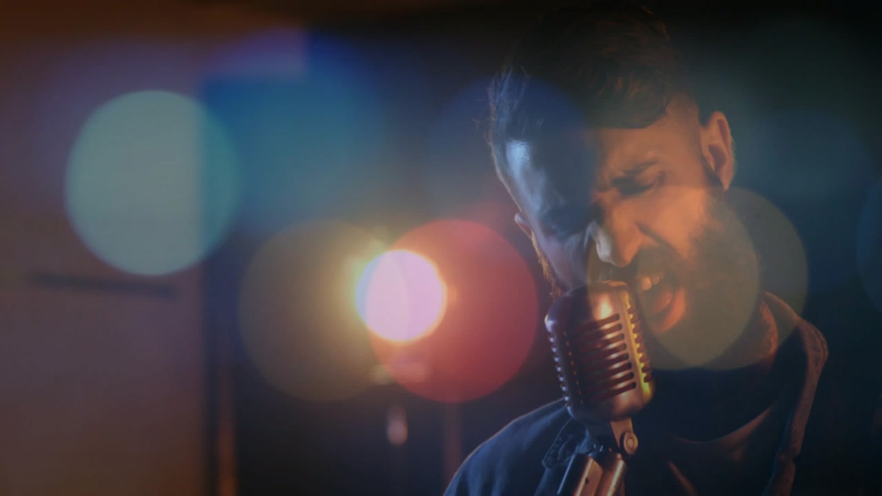 Camera cutting, drummer hitting cymbals and guitar strumming while vocalist singing to build energy