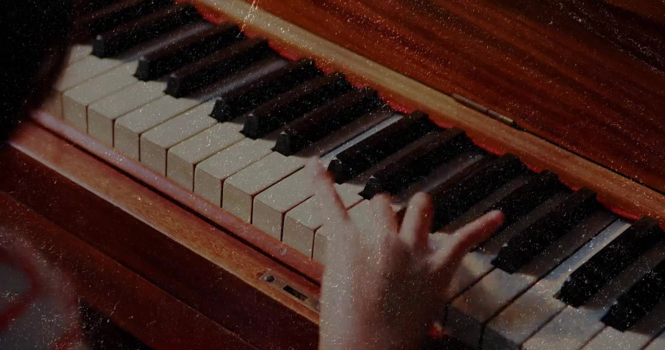 Girl initiating piano melody by pressing mid-range key and gliding right for music education